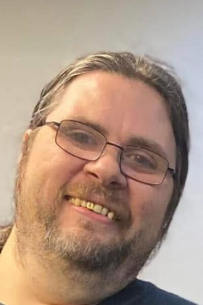 white man with blond hair and beard and glasses smiling